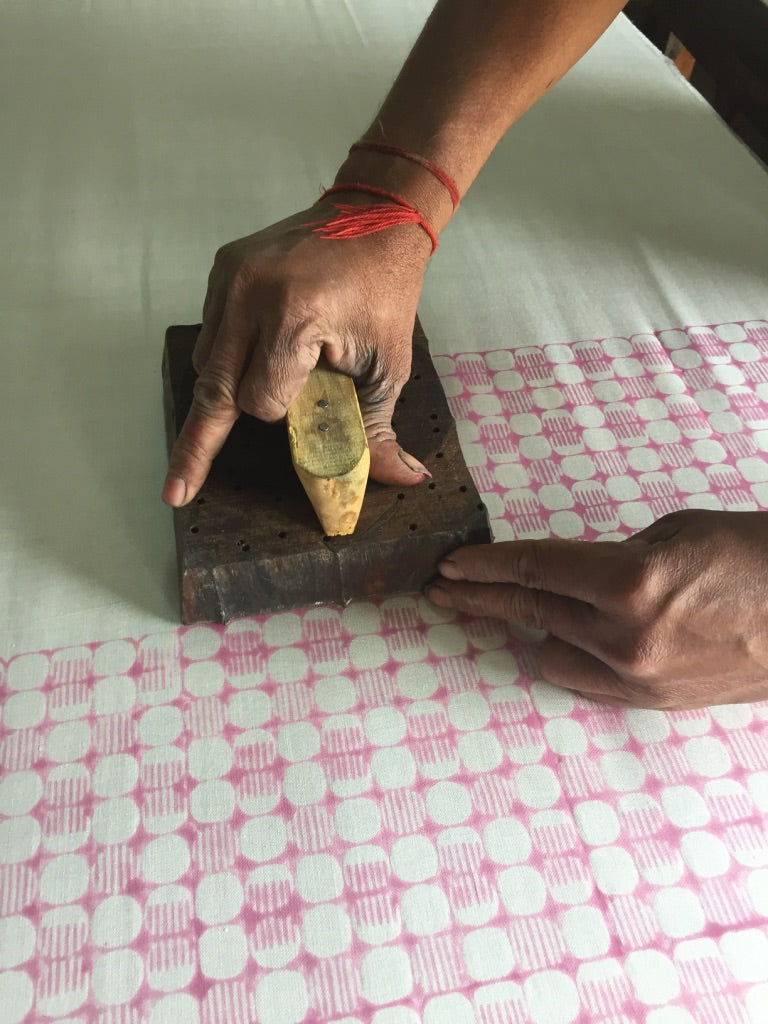 A man displaying the craft of block printing mulberry silk